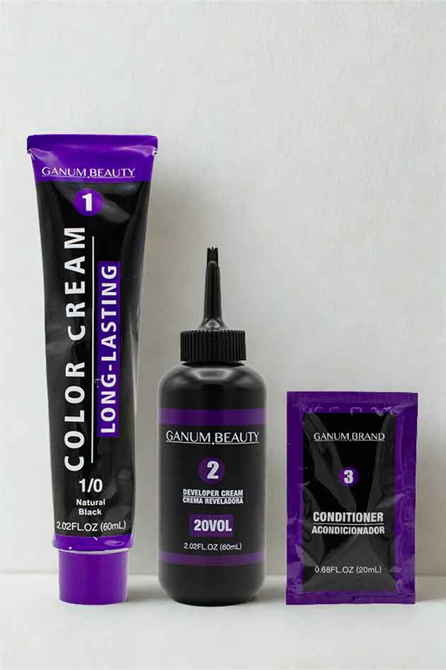 Natural Black 1/0 hair color cream by Ganum Beauty on white background. Ganum Beauty hair color products including a tube, bottle, and packet on a white background