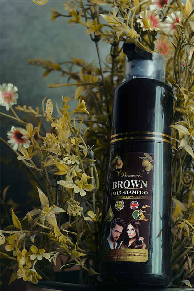 Hair shampoo bottle with branding and product details, surrounded by flowers.