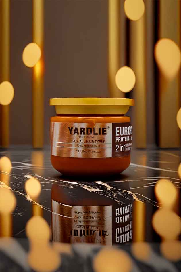 Jar of Yardlie Euro Protein on a reflective surface with blurred lights in the background