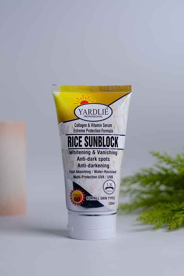 Yardlie rice sunblock water resistant sunscreen for all skin types. Yardlie Rice Sunblock tube on a light gray background with greenery