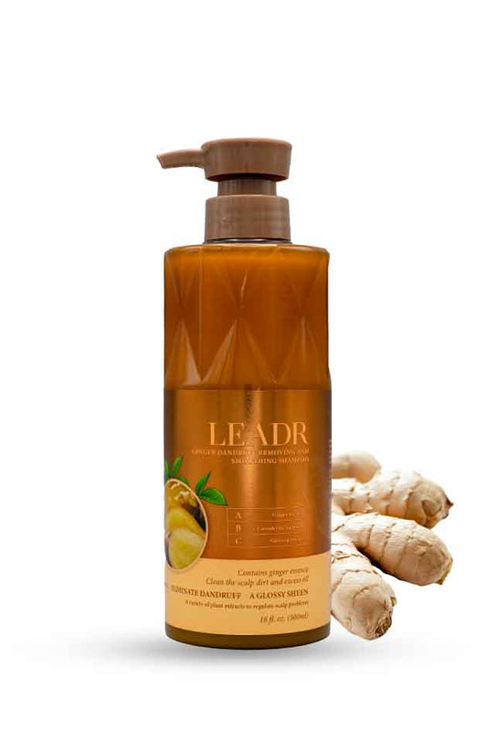 LEADR Ginger Anti-Dandruff & Smoothing Shampoo 500ml bottle with fresh ginger roots, Bottle of LEADR product with ginger root on a white background