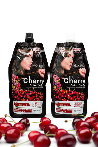 Mokeru Cherry Ammonia Free Black Hair Color Cream 500ml pack for grey coverage in Pakistan,
Two black squeeze pouches of Mockeru Cherry Color Cream are displayed on a white background, surrounded by fresh red cherries at the bottom. The packaging features a portrait of a woman with dark hair and a graphic of red cherries.