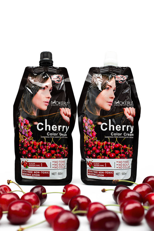 Mokeru Cherry Ammonia Free Black Hair Color Cream 500ml pack for grey coverage in Pakistan,
Two black squeeze pouches of Mockeru Cherry Color Cream are displayed on a white background, surrounded by fresh red cherries at the bottom. The packaging features a portrait of a woman with dark hair and a graphic of red cherries.
