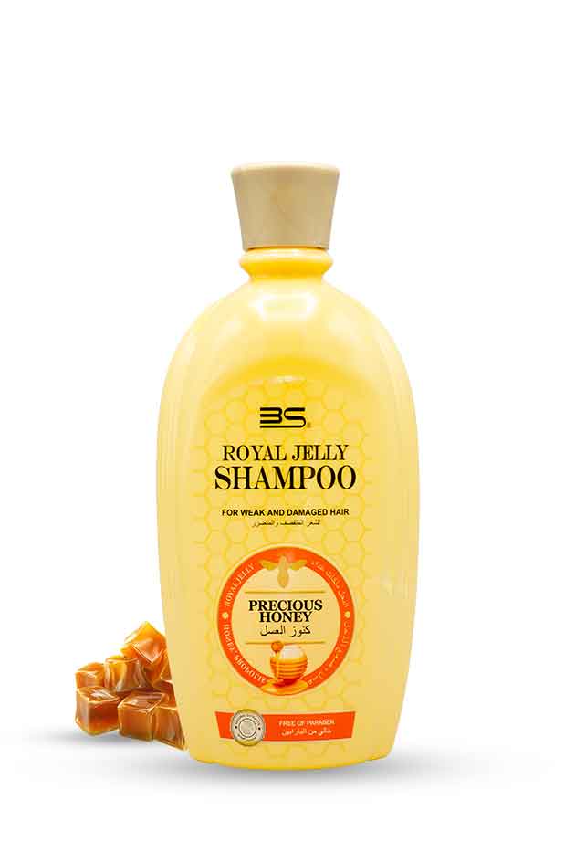 Yellow shampoo bottle with a honey comb design on a white background