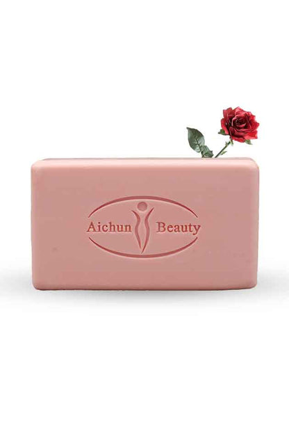Aichun Beauty Rose Soap – Moisturizing and Whitening Multi-Purpose Face and Body Bar with Rose Extract. Pink bar of soap with 'Aichun Beauty' branding and a red rose on a white background