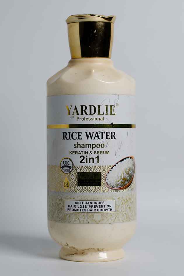 Yardlie Rice Water Shampoo 2-in-1 bottle with slightly damaged box. Yardlie Rice Water shampoo bottle on a gray background