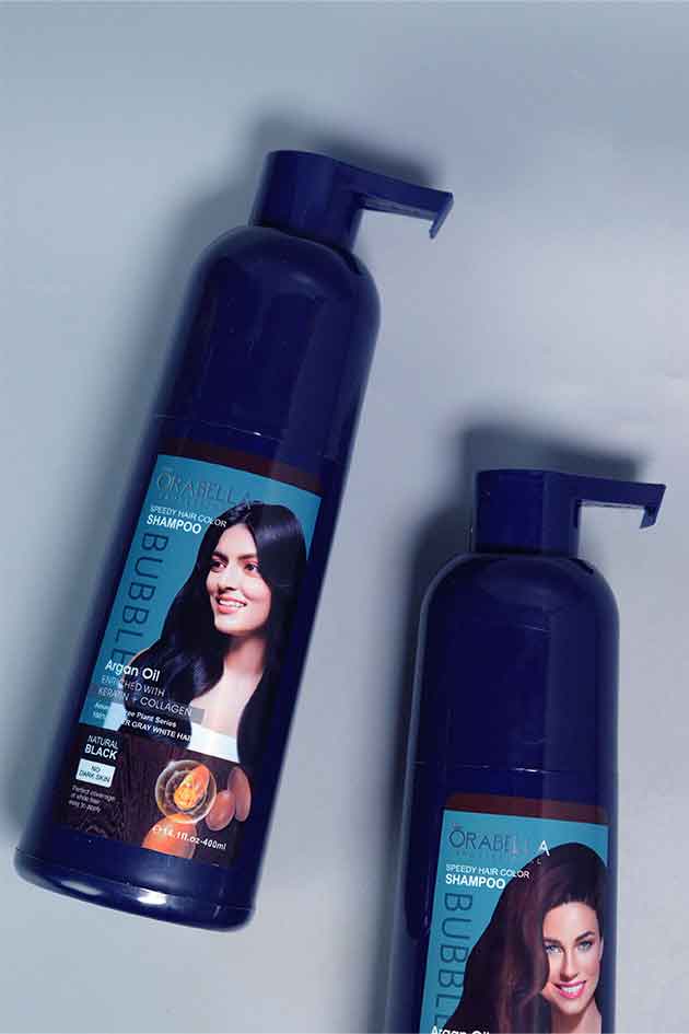 Applying Orabella Speedy Hair Color Shampoo on hair – quick black color transformation with nourishing shine. Two bottles of 'Or Al' shampoo with pump on a light gray background