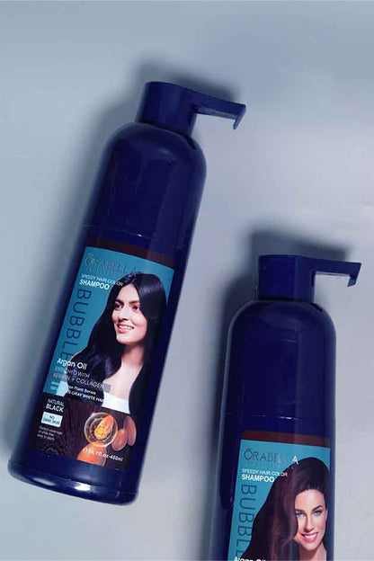 Applying Orabella Speedy Hair Color Shampoo on hair – quick black color transformation with nourishing shine. Two bottles of 'Or Al' shampoo with pump on a light gray background
