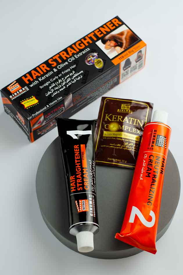 Hair straightening products including a box, cream tube, and packets on a gray surface. Yardlie Keratin Hair Straightener and Neutralizing Cream with Olive Oil  professional frizz control and hair smoothing kit