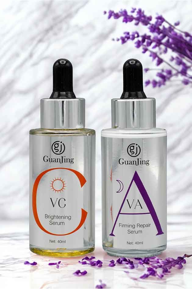 Two skincare serum bottles with droppers on a white background with lavender flowers.