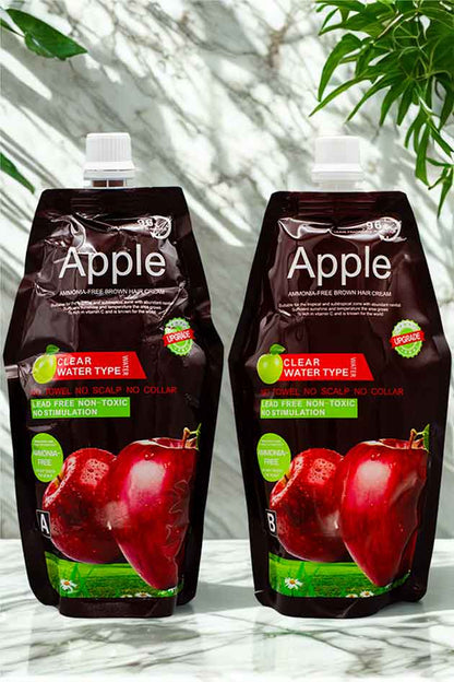 Ammonia-free apple hair color cream with no scalp irritation and 96-hour fragrance. Two Apple juice pouches on a marble surface with a blurred green leafy background