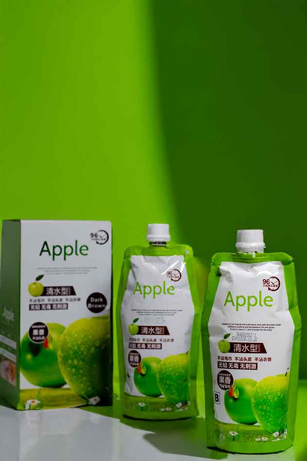 Green Apple juice packaging with a box on a green background