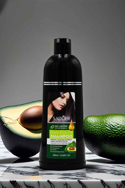 Instant 5-Minute Natural Black Hair Color Shampoo for Grey Hair Coverage. Shampoo bottle with avocado on a marble surface