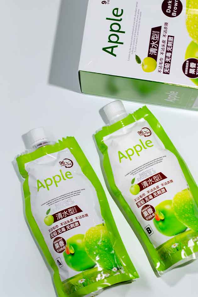 Two green juice packs with 'Apple' branding on a white background
