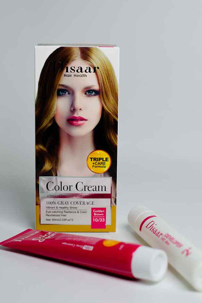 DIsaar hair color cream packaging with a tube and applicator on a gray background