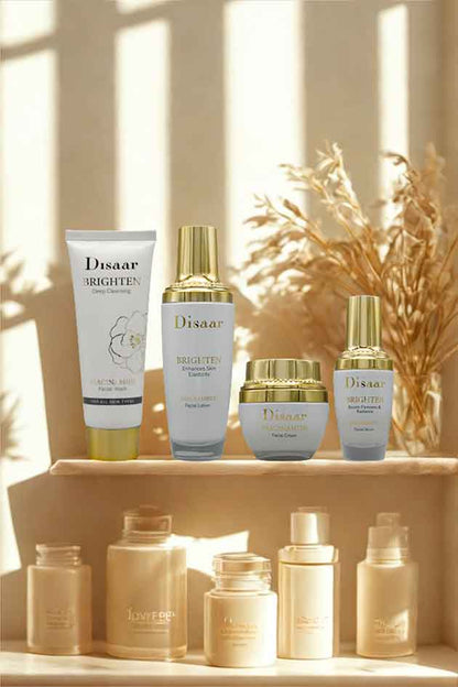 Disaar Niacinamide 4-in-1 Brighten Skincare Kit – facial wash, lotion, cream, and serum for glowing hydrated skin. Set of Disaar skincare products on a wooden shelf with a warm, natural light background.