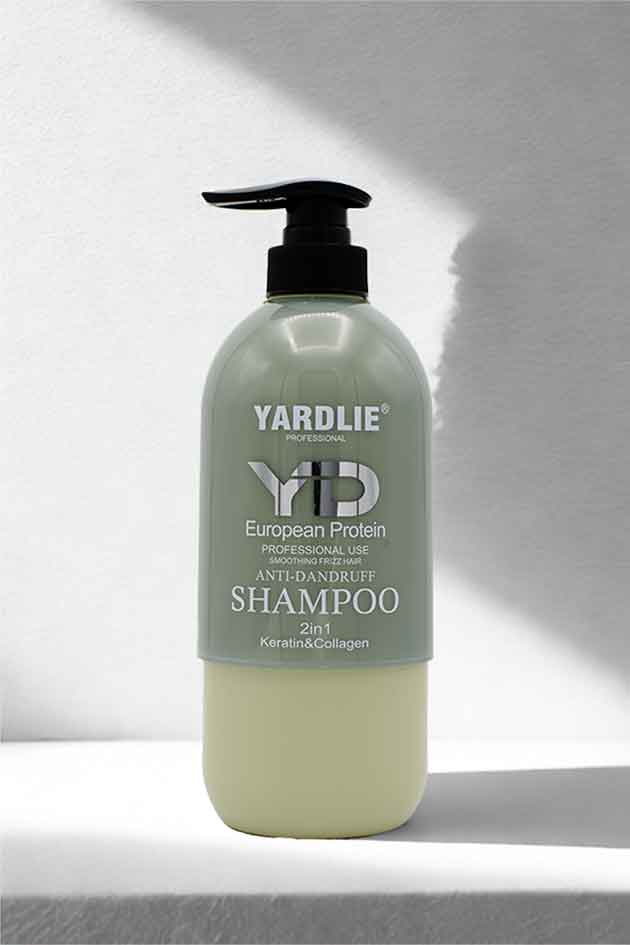 Keratin and Collagen ingredient highlight around Yardlie smoothing shampoo on minimal studio backdrop. Yardlie shampoo bottle on a white background