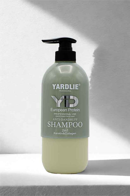 Keratin and Collagen ingredient highlight around Yardlie smoothing shampoo on minimal studio backdrop. Yardlie shampoo bottle on a white background