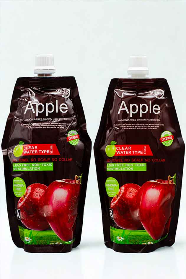 Lead-free non-toxic brown hair dye cream with clear water technology. Two bottles of Apple juice with red apples on a white background