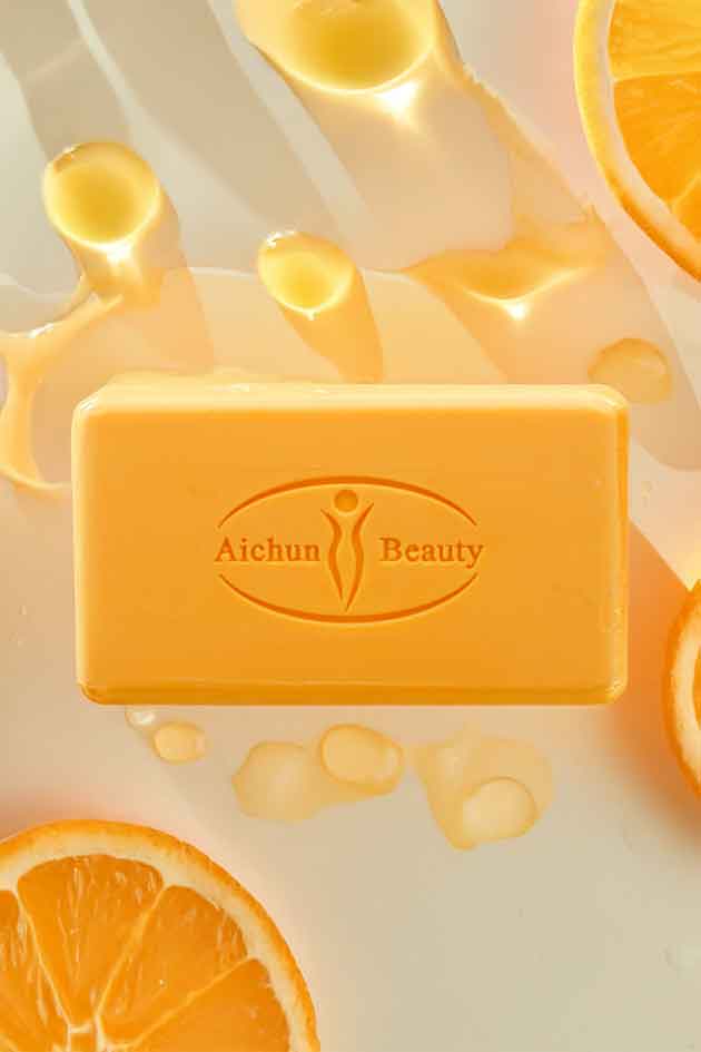Bar of soap with 'Aichun Beauty' branding on a background of orange slices.