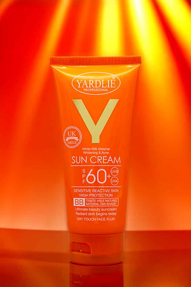 Yardlie sun cream bottle with a bright orange background