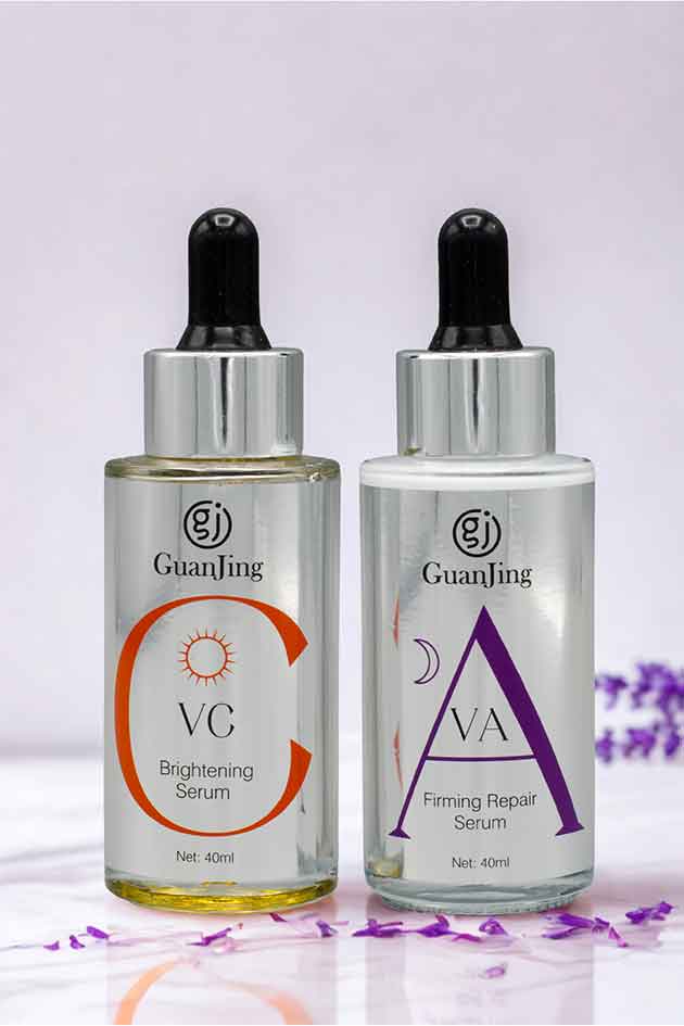 Two skincare serum bottles with droppers on a light purple background