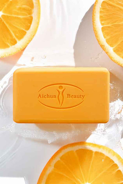Bar of Aichun Beauty soap with orange slices on a white background