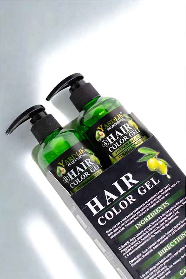 Two bottles of hair color gel with pump dispensers on a reflective surface.