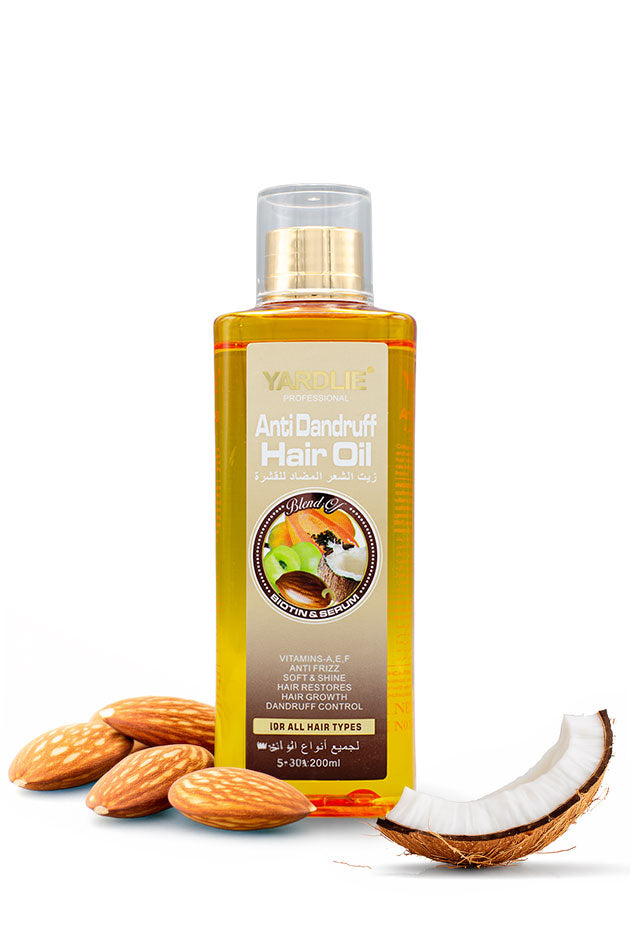 Yardlie Nourishing Hair Oil with Coconut and Papaya 200ml Online in Pakistan,
A bottle of Yardlie Anti Dandruff Hair Oil with a gold cap, displayed on a white background with almonds and a halved coconut at its base.