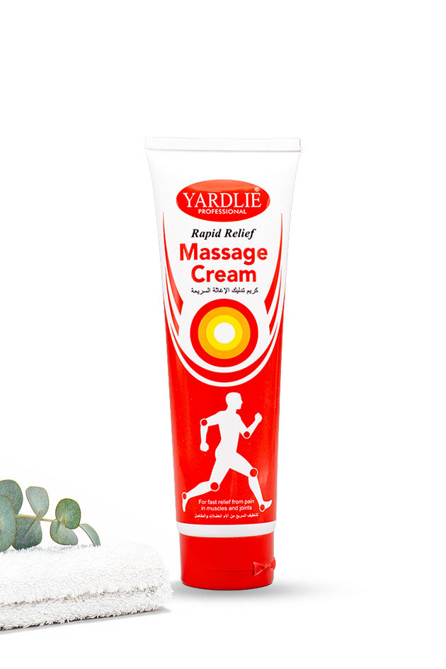 Yardlie Professional Rapid Relief Massage Cream 100ml tube box for muscle massage,
A tube of Yardlie Professional Massage Cream with a red and white label, standing upright on a white surface next to a folded white towel and a small green eucalyptus sprig, against a white background.