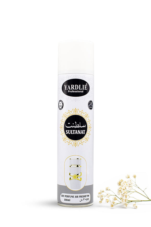 Yardlie Professional Sultanat Dry Perfume Air Freshener 300ml white and gold can,
A white aerosol can of Yardli Professional Sultanat perfume air freshener, shown on a clean white background with small white flowers at the bottom right.