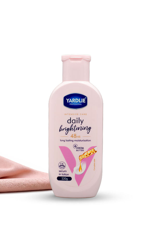Yardlie Professional Daily Brightening cocoa butter serum in lotion body lotion 220g pink bottle,
A bottle of Yardlie Daily Brightening 4 Skin long lasting moisturiser in a pale pink bottle with a pink cap, shown on a white background with a folded pink towel behind it.