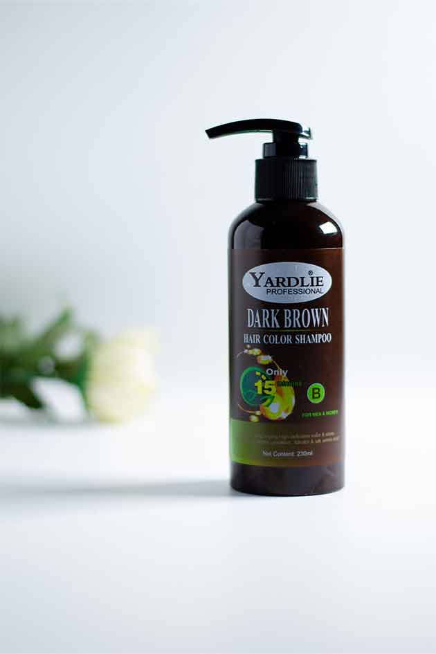 Two pump bottles of Yardlie Professional Hair Dye Shampoo Mixing Paste in Dark Brown color, with product information and ingredients visible on the labels.